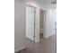 Hallway showcases open door to bathroom, wood-look floors, and white walls at 16450 Se 57Th Pl, Ocklawaha, FL 32179