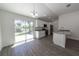 Modern kitchen with white cabinets, granite countertops, stainless steel appliances, and a sliding glass door at 16450 Se 57Th Pl, Ocklawaha, FL 32179