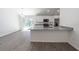 Modern kitchen showcasing white cabinetry, stainless steel appliances, and granite countertops with stylish fixtures at 16450 Se 57Th Pl, Ocklawaha, FL 32179