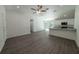 Inviting living room featuring sleek flooring and a view of the modern kitchen and dining area at 16450 Se 57Th Pl, Ocklawaha, FL 32179