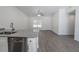 Living area with granite counters, stainless steel sink and modern flooring and natural light at 16450 Se 57Th Pl, Ocklawaha, FL 32179