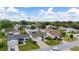 Aerial view showing homes and well-maintained lawns at 17606 Se 93Rd Butler Ct, The Villages, FL 32162