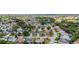 Aerial view of a residential community with houses, roads, and greenery at 17606 Se 93Rd Butler Ct, The Villages, FL 32162
