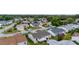Aerial view of a residential area featuring houses, roads, and green spaces at 17606 Se 93Rd Butler Ct, The Villages, FL 32162