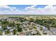 Aerial view of a residential area with houses, trees, and a golf course in the distance at 17606 Se 93Rd Butler Ct, The Villages, FL 32162