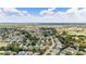 Aerial view showcasing a neighborhood with houses, golf course, and a lake at 17606 Se 93Rd Butler Ct, The Villages, FL 32162