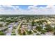 Aerial view of a large community with numerous houses and lush green spaces at 17606 Se 93Rd Butler Ct, The Villages, FL 32162