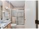 Clean bathroom with a walk-in shower and granite countertop at 17606 Se 93Rd Butler Ct, The Villages, FL 32162