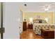Spacious bedroom with floral bedding and ceiling fan at 17606 Se 93Rd Butler Ct, The Villages, FL 32162