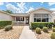 Front entryway with walkway, landscaping and white railing at 17606 Se 93Rd Butler Ct, The Villages, FL 32162