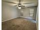 Comfortable bedroom featuring plush carpeting, window blinds, and a modern ceiling fan with light fixture at 1936 Se 37Th Court Cir, Ocala, FL 34471