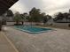 Outdoor community pool area with surrounding brick patio and seating at 1936 Se 37Th Court Cir, Ocala, FL 34471
