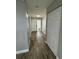 Inviting hallway with wood-look floors, closet, and view of the front door at 1936 Se 37Th Court Cir, Ocala, FL 34471