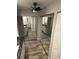 Hallway features wood floors and mirrored closet doors, leading to bathroom vanity at 1936 Se 37Th Court Cir, Ocala, FL 34471