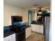Contemporary kitchen with stainless steel appliances, dark countertops, and white cabinetry at 1936 Se 37Th Court Cir, Ocala, FL 34471