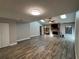 Bright living room with vaulted ceiling, skylights, wood-look flooring, and fireplace at 1936 Se 37Th Court Cir, Ocala, FL 34471