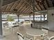 Covered poolside pavilion with tables, chairs, bar seating, and a wood slat ceiling at 1936 Se 37Th Court Cir, Ocala, FL 34471