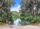 Swimming area with a fenced-in spring and steps to enter the water at 19660 Sw 83Rd Place Rd # C18, Dunnellon, FL 34432