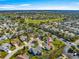 Enjoy this aerial view of a well-maintained neighborhood with lush greenery and expansive golf course views at 2630 Dunbar Ave, The Villages, FL 32162
