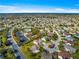 Aerial view of a quiet neighborhood featuring a community pool and lush green landscaping throughout at 2630 Dunbar Ave, The Villages, FL 32162