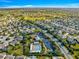 Wide aerial view of the neighborhood showing the pool, surrounding homes, and community landscape at 2630 Dunbar Ave, The Villages, FL 32162