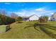 Expansive backyard featuring lush green grass, mature landscaping, and a screened lanai for outdoor enjoyment at 2630 Dunbar Ave, The Villages, FL 32162