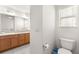 Bathroom featuring double sinks, granite counters, tiled floor, and linen closet at 2630 Dunbar Ave, The Villages, FL 32162