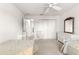 Comfortable bedroom featuring twin beds, closet, ceiling fan, and hallway access at 2630 Dunbar Ave, The Villages, FL 32162