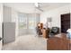 Bright bedroom featuring a large bay window providing natural light, complemented by a ceiling fan at 2630 Dunbar Ave, The Villages, FL 32162