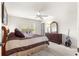 Bright bedroom featuring neutral carpet, ceiling fan, and dark wood dresser with decorative mirror at 2630 Dunbar Ave, The Villages, FL 32162