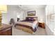 Bedroom features neutral carpet, ceiling fan, blinds, and decorative bedding with ornate wood headboard at 2630 Dunbar Ave, The Villages, FL 32162