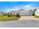 Traditional single story home with a brick driveway, an attached garage and well-maintained front lawn at 2630 Dunbar Ave, The Villages, FL 32162