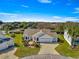 Charming home featuring a brick driveway, well-manicured landscaping and an attached two-car garage at 2630 Dunbar Ave, The Villages, FL 32162