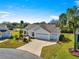 Charming home featuring a brick driveway, well-manicured landscaping and an attached two-car garage at 2630 Dunbar Ave, The Villages, FL 32162