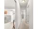 Bright hallway with neutral carpet, leading to various rooms, showcasing the home's open layout at 2630 Dunbar Ave, The Villages, FL 32162