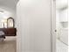 Hallway leading to a bedroom with a dresser and a laundry room with a washing machine at 2630 Dunbar Ave, The Villages, FL 32162