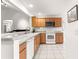 Well-lit kitchen with stainless steel appliances, granite countertops, and a breakfast bar at 2630 Dunbar Ave, The Villages, FL 32162