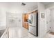 Bright kitchen with stainless steel refrigerator, ample counter space, and tile flooring at 2630 Dunbar Ave, The Villages, FL 32162