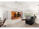 Spacious living room with vaulted ceiling, large entertainment center, and sliding glass doors at 2630 Dunbar Ave, The Villages, FL 32162