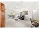 Bright living room featuring high ceilings, neutral colored walls, and sliding door to the screened lanai at 2630 Dunbar Ave, The Villages, FL 32162