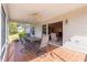 Covered screened patio featuring a ceiling fan and ceramic tile at 2630 Dunbar Ave, The Villages, FL 32162