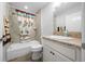 Bathroom with shower/tub combo, granite countertop vanity, and patterned shower curtain at 2925 Chimborazo Way, The Villages, FL 32163