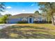 Single-story house with a two-car garage and well-maintained lawn at 3020 Se 45Th Ct, Ocala, FL 34480