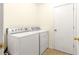 Bright laundry room features a washer and dryer, and an additional storage area at 3020 Se 45Th Ct, Ocala, FL 34480