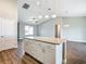 White kitchen island with granite countertop and ample storage at 3219 Se 43Rd Ave, Ocala, FL 34480