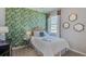Bright bedroom with tropical-themed wallpaper and a comfortable bed at 4062 Nw 44Th Cir, Ocala, FL 34482