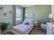 Charming bedroom featuring a green accent wall and a cozy bed at 4062 Nw 44Th Cir, Ocala, FL 34482
