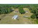 Wide aerial view of a property with multiple buildings and a pond at 4248 Ne 175Th Street Rd, Citra, FL 32113