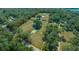 Wide aerial view of property with two homes, a barn and pond at 4248 Ne 175Th Street Rd, Citra, FL 32113