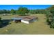 Aerial view of a home with a carport and spacious yard at 4248 Ne 175Th Street Rd, Citra, FL 32113